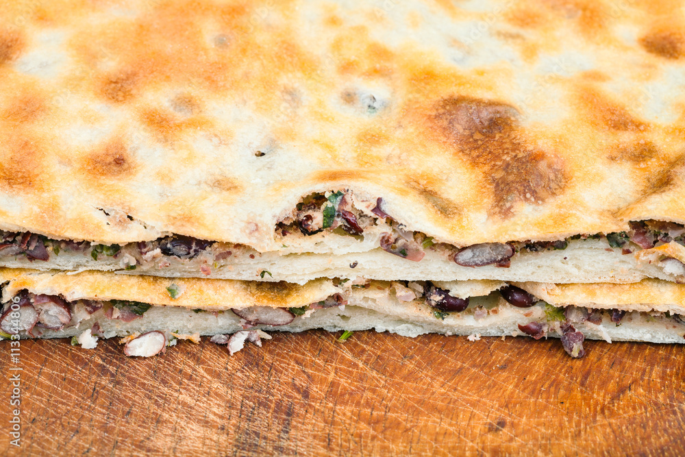 cutting bean filled bread (Lobiani) close up cutting bean filled bread (Lobiani) close up