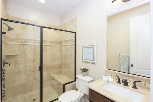 Bathroom with glass shower and rectangle wash basin.