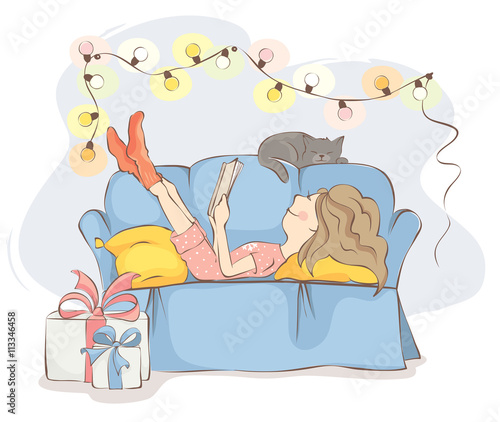 Fototapeta Naklejka Na Ścianę i Meble -  Christmas Holidays/Young woman or girl is lying on the sofa reading a book, near cat sleeps. All wait the holiday.