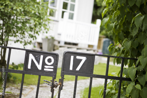 House number 17 on closed metal gate photo