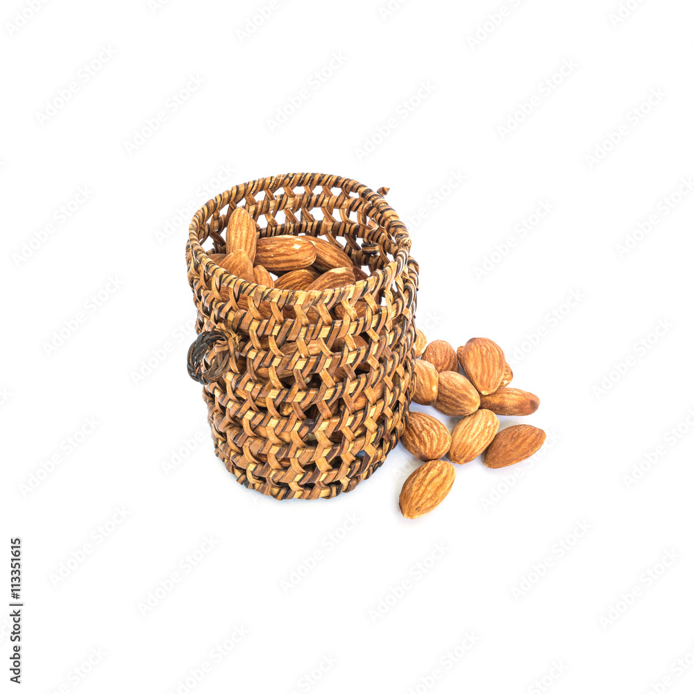 Closeup pile of dried nuts , energy food , almond with wooden wickerwork isolated on white background with clipping path