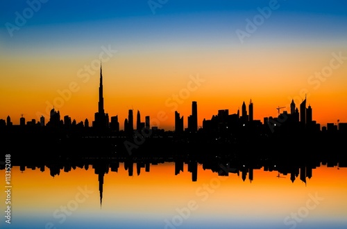 High rise buildings during stunning sunset in Dubai, UAE. 