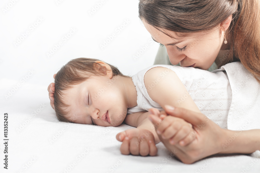 Mother kissing a baby. Care concept Mother kissing a baby. Care concept