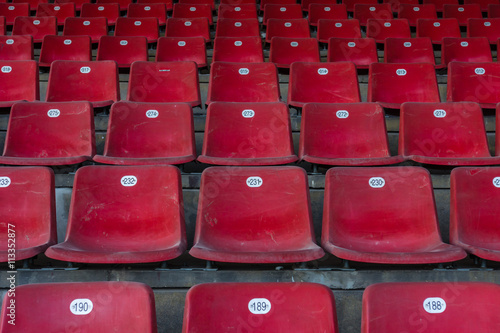 Empty and old plastic seats in the stadium.