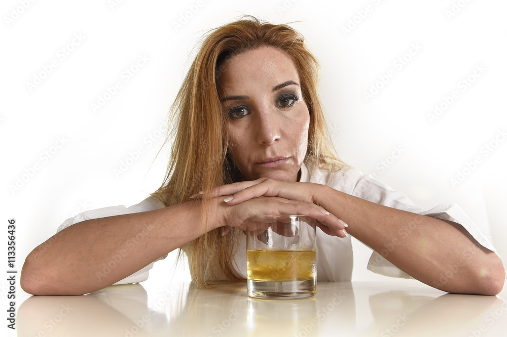 caucasian blond wasted and depressed alcoholic woman drinking scotch whiskey glass messy drunk