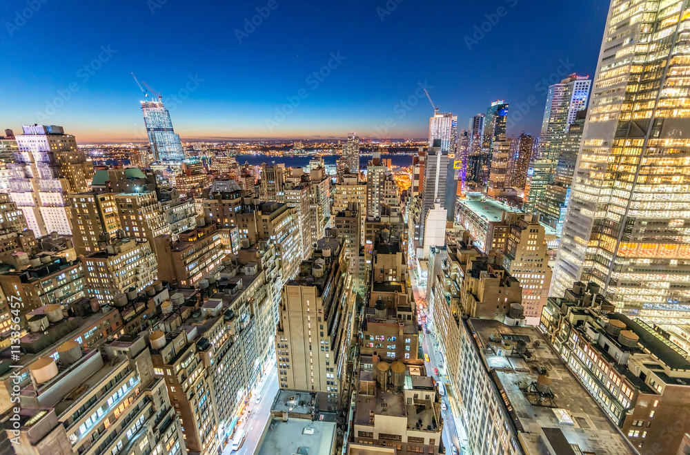 Fototapeta premium Manhattan skyscrapers at night as seen from New York rooftop