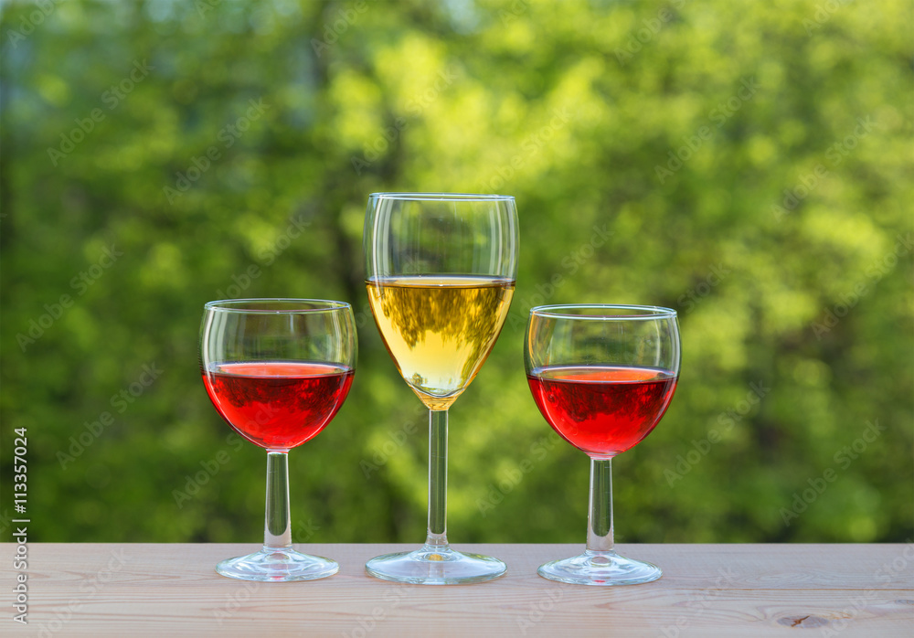  three wine glasses on table in the garden
