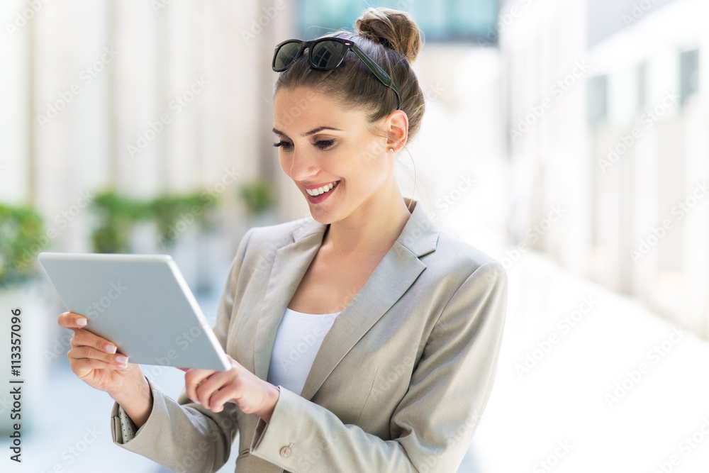 Attractive young woman using digital tablet
Attractive young woman using digital tablet