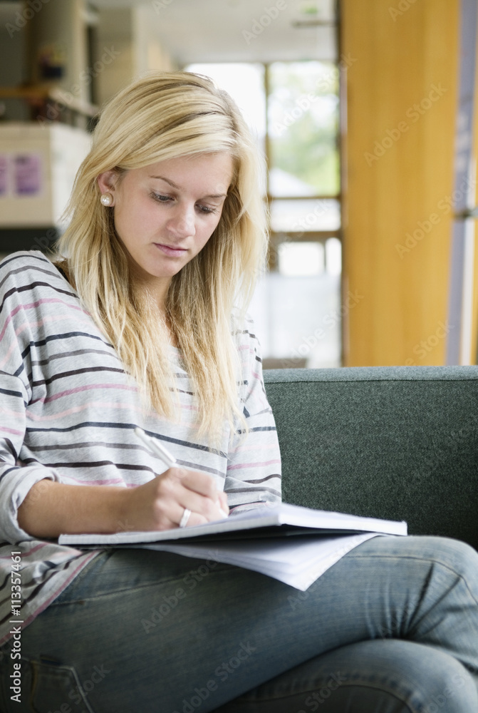 Concentrated girl sitting in sofa Concentrated girl sitting in sofa