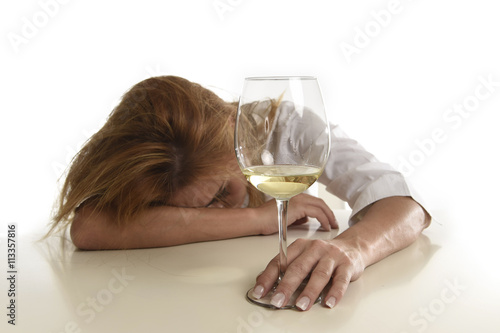 caucasian blond wasted and depressed alcoholic woman drinking white wine glass desperate drunk