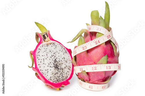 Dragon fruit with a tape measure isolated on white