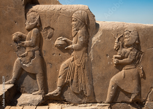 Bas Relief Carvings of Dignitaries and Representatives Bringing Gifts to the King in Persepolis photo