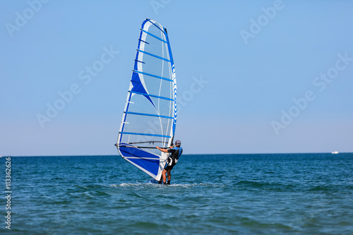 Windsurfer with windsurf on sea waves