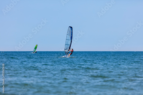 Windsurfer with windsurf on sea waves