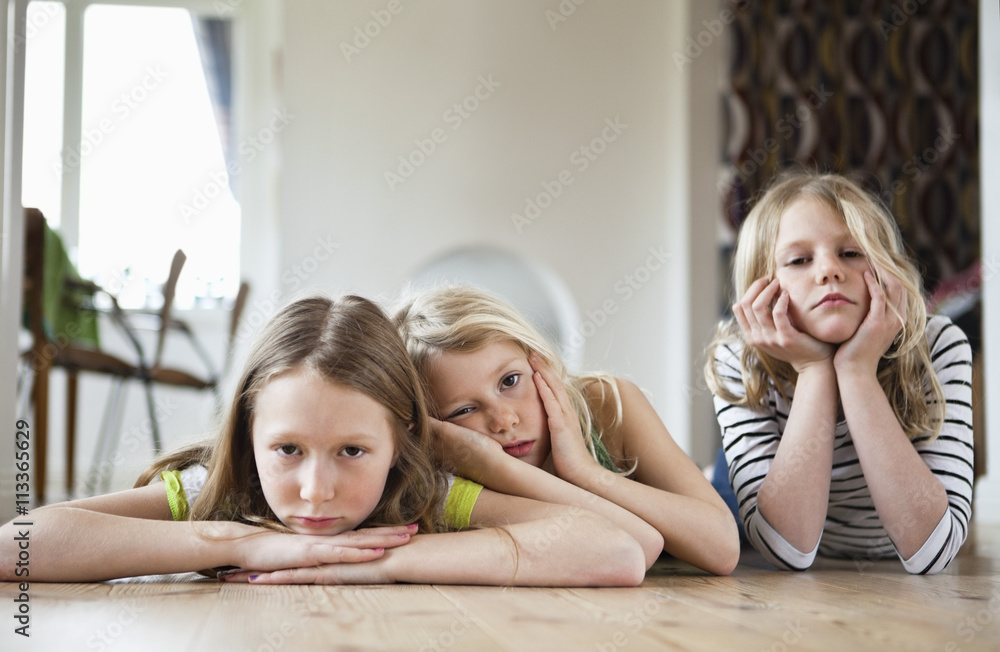 Three girls lying on floor Stock Photo | Adobe Stock