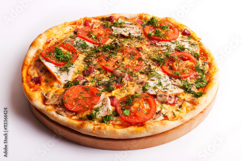 Pizza with ham, tomatoes and mushrooms isolated on white