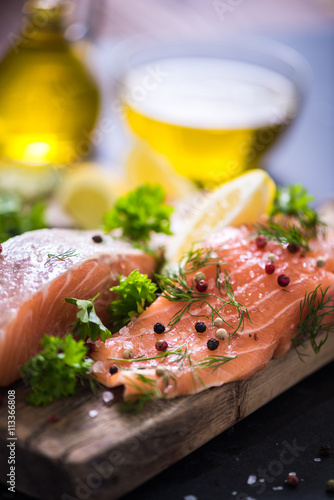 salmon steaks on wooden board marinated