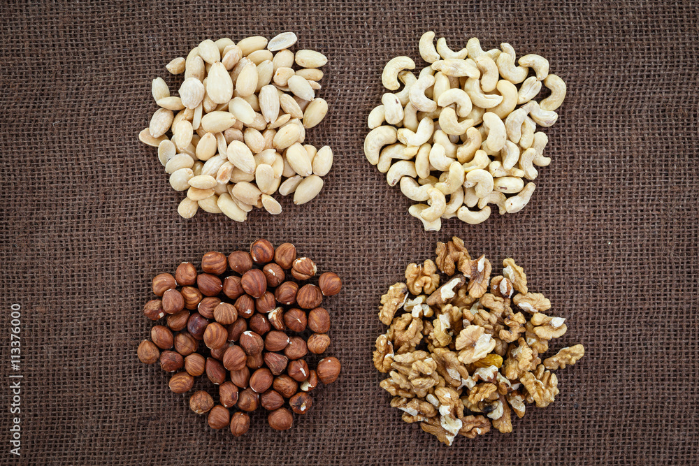 Almonds, cashew, walnuts and hazelnuts lying on burlap Almonds, cashew, walnuts and hazelnuts lying on burlap