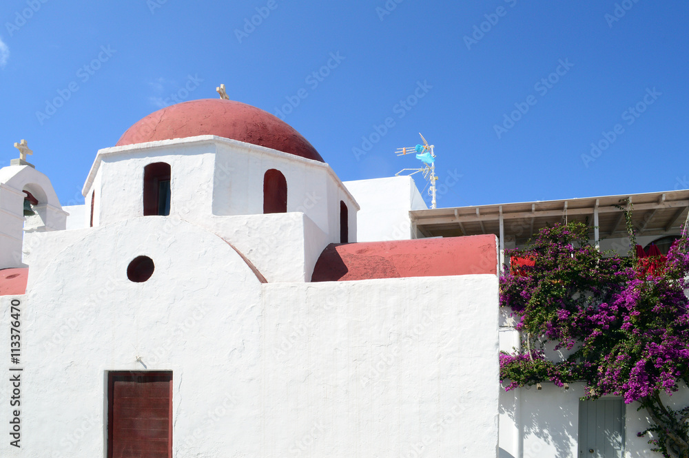 A white church with red roof on Mykonos island, Greece
