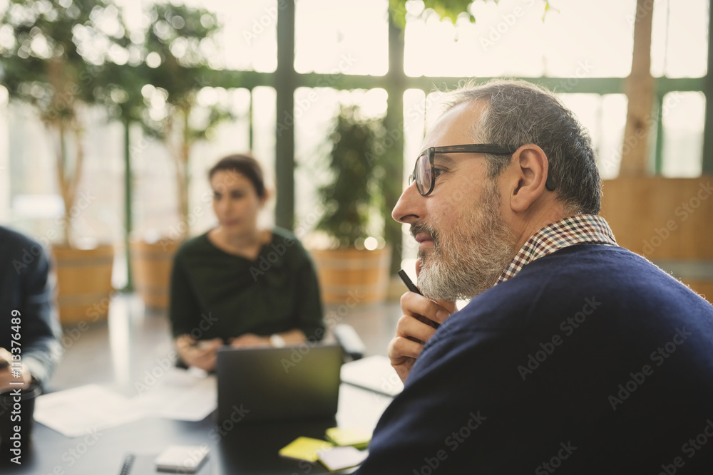 Business people talking while sitting in office meeting Business people talking while sitting in office meeting