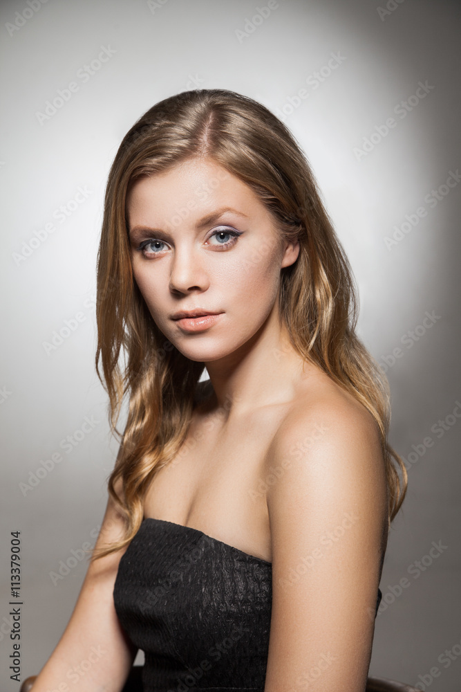 Beautiful woman with long wavy hair looking at camera Beautiful woman with long wavy hair looking at camera