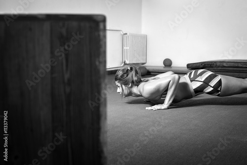 Girl doing push-ups in gym