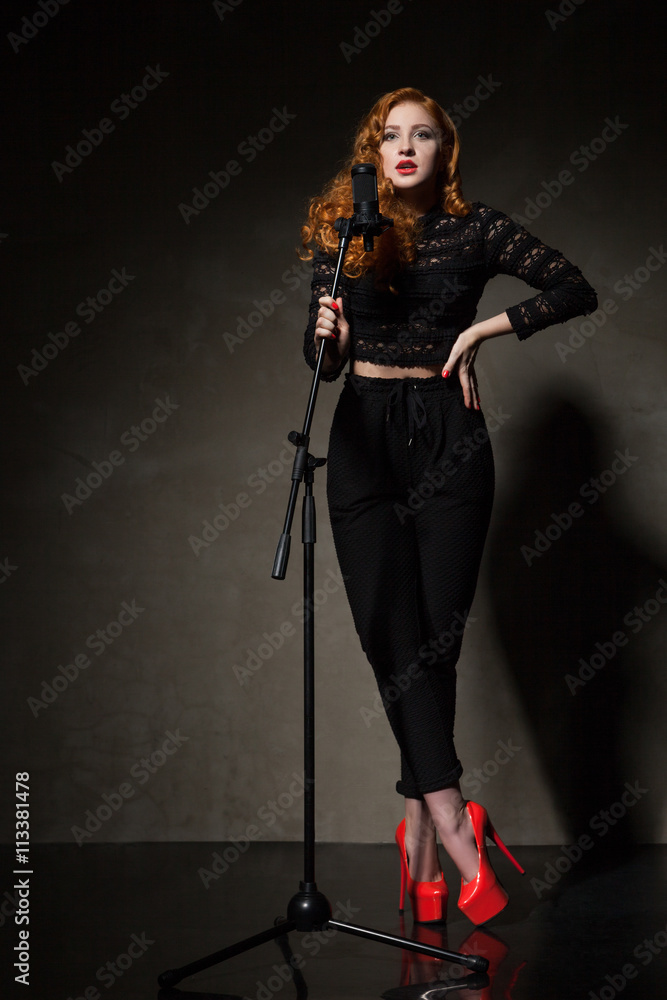 Portrait of beautiful singer in red heels and black clothes Portrait of beautiful singer in red heels and black clothes