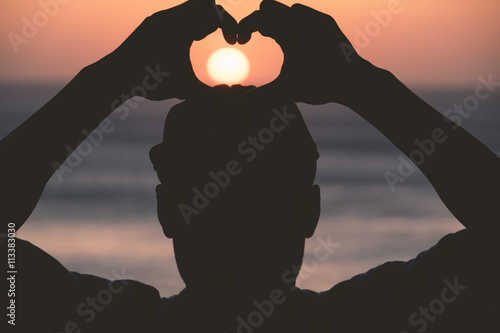 Canvas Print Man showing heart during sunset in Morocco