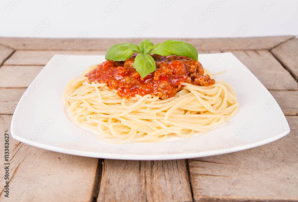 Spaghetti bolognese on a plate on a wooden background Spaghetti bolognese on a plate on a wooden background