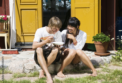 Guy and girl sitting outside dorr photo