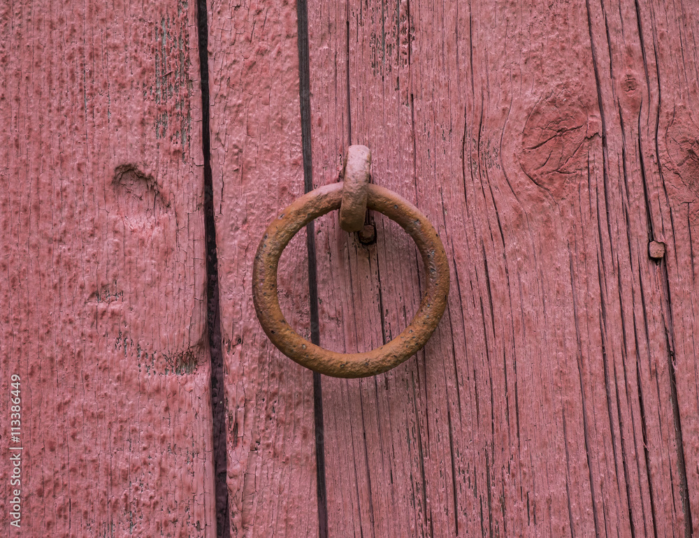 Horse Tie Off Ring: An old iron ring used to tie a horse to on the side of an red barn Horse Tie Off Ring: An old iron ring used to tie a horse to on the side of an red barn