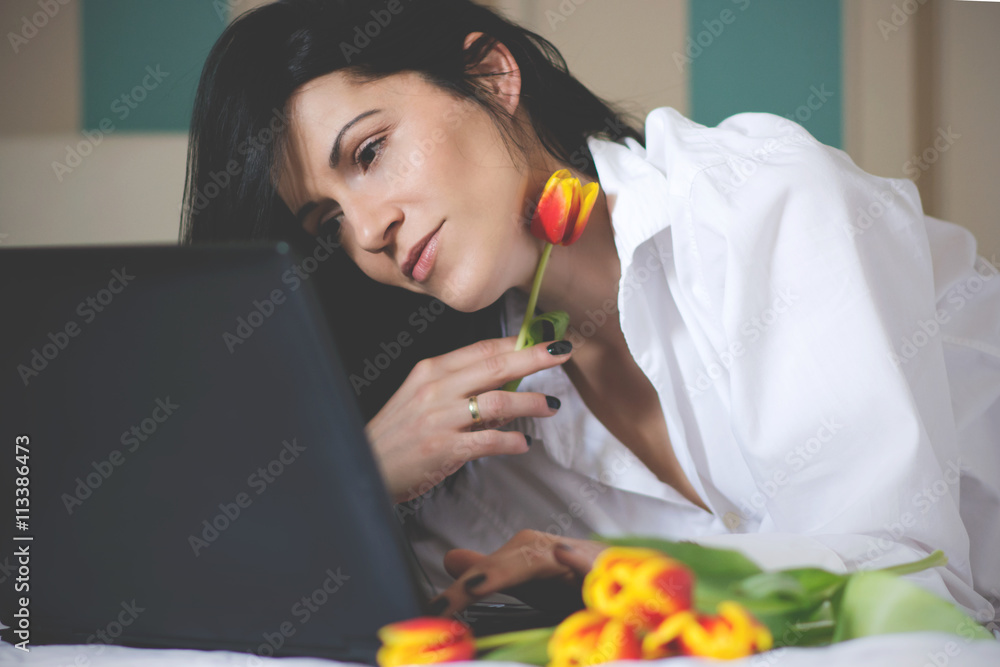 Black haired young woman in her bed in the morning Black haired young woman in her bed in the morning