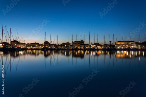 A calm night in Lefkas, Greece. Yachts docked in the city marina. photo