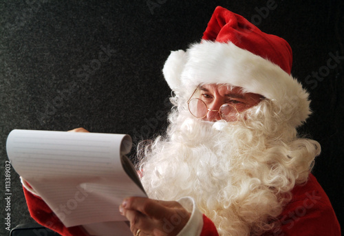 Santa Claus writing a wish list photo