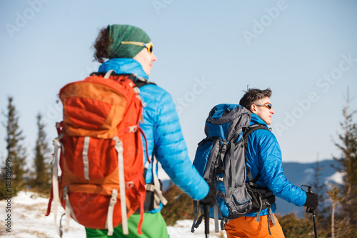 Two hikers in winter mountains
