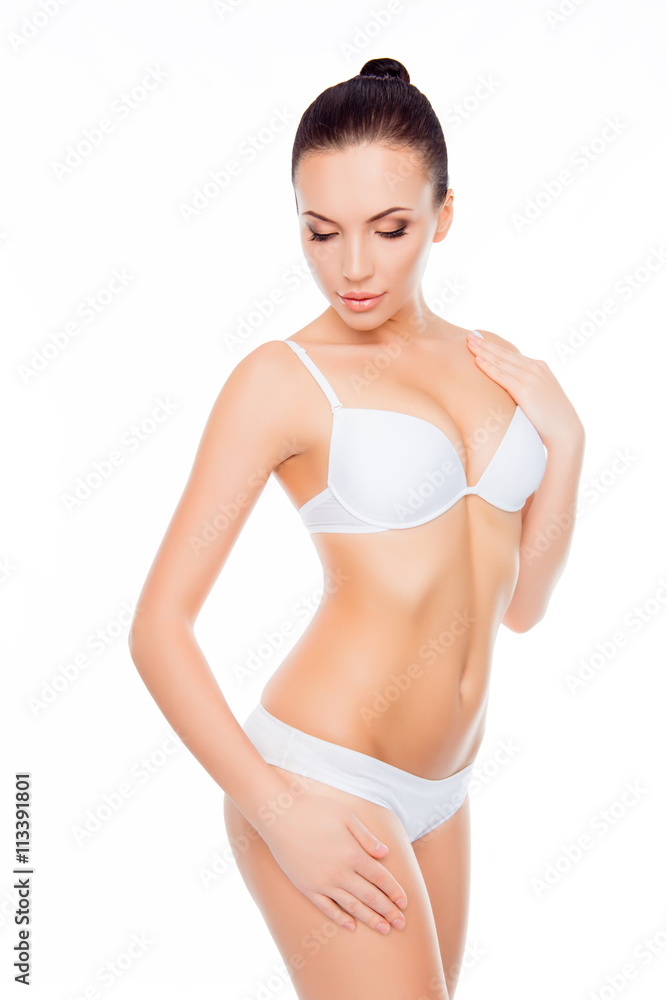 Fototapeta premium Sensual healthy woman demonstrating her slim body in white linge