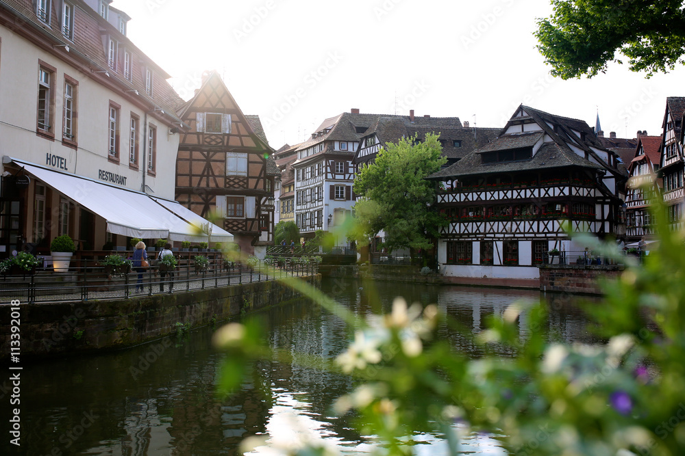 Summer day in Strasbourg. Medieval cityscape of Rhineland black and white timber-framed buildings in the Petite-France district alongside the river Ill on sunny day - France, Alsace region.