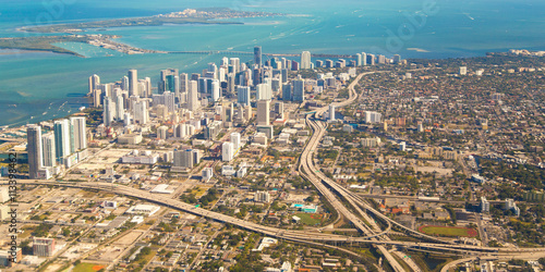 The City of Miami, Florida with Downtown and Key Biscayne. Boats are riding in a bay of Atlantic Ocean.