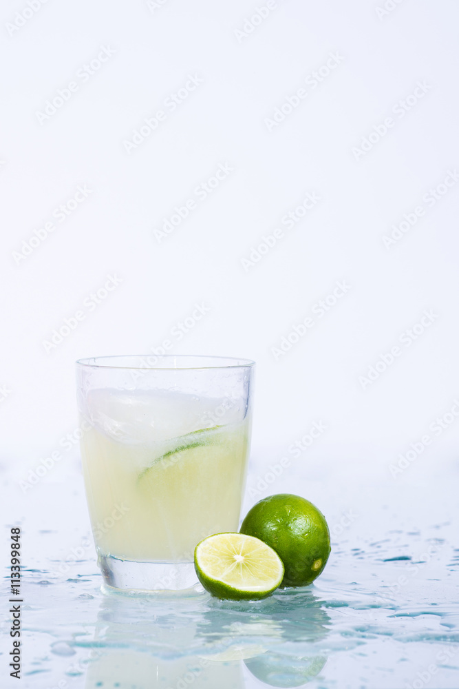 Fototapeta premium Lemon juice in a glass.Isolated on white.