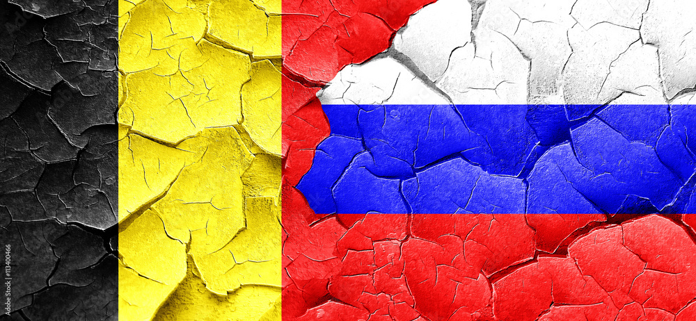 Belgium flag with Russia flag on a grunge cracked wall