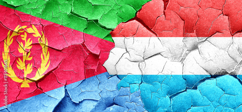 Eritrea flag with Luxembourg flag on a grunge cracked wall