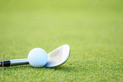 Golf ball on green grass in course