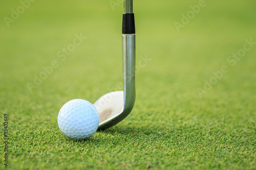 Golf ball on green grass in course