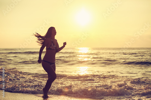 Silhouette of carefree woman on the beach