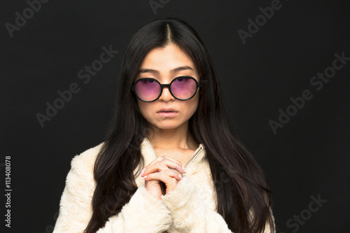 Portrait of fashion asian model woman in sunglasses in studio. Brunette lady posing for fashion magazine. Vogue concept. photo