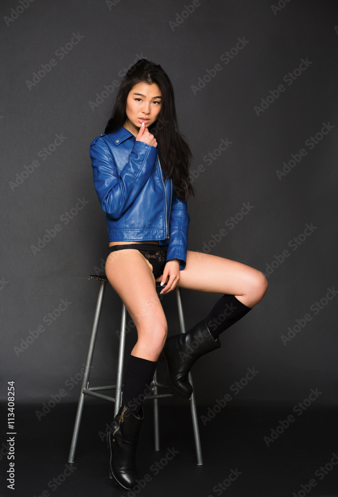 Portrait of sexy lady posing for photographer over grey background