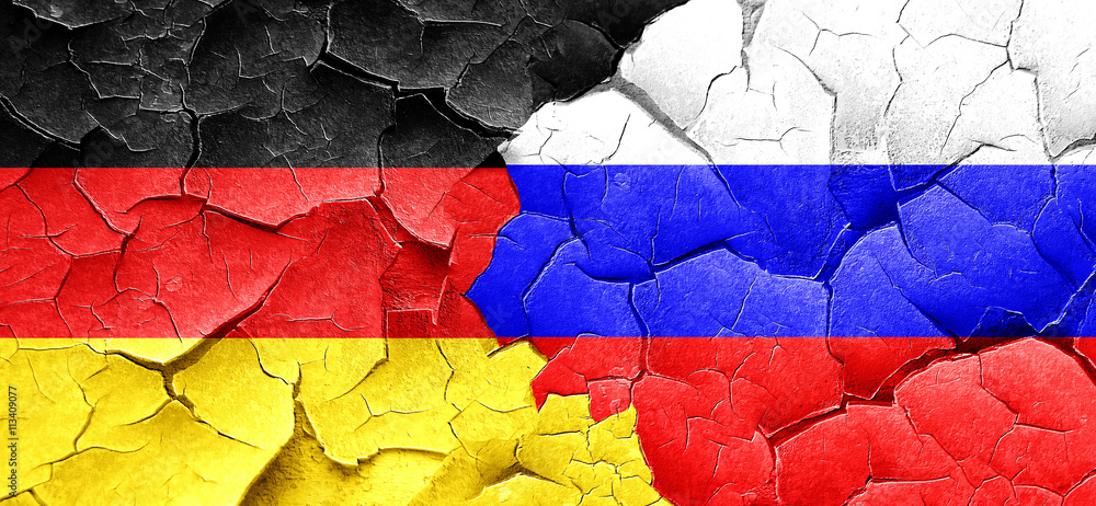 German flag with Russia flag on a grunge cracked wall