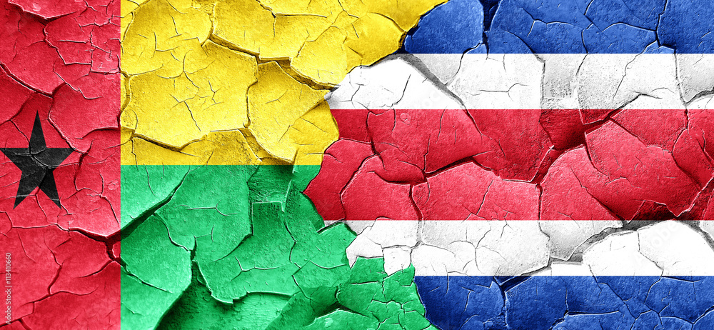 Guinea bissau flag with Costa Rica flag on a grunge cracked wall