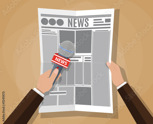 hand holding a microphone and newspaper