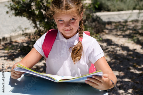 junior school pupil is reading a textbook